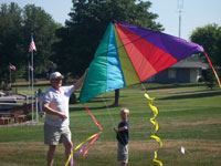 Manahawkin back pain free grandpa and grandson playing with a kite