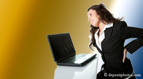a person Manahawkin bending over a computer holding her back due to pain